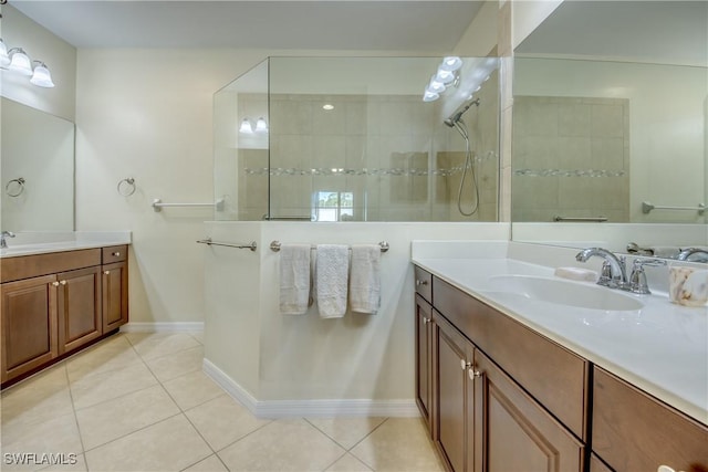 bathroom featuring tile patterned flooring, vanity, and tiled shower