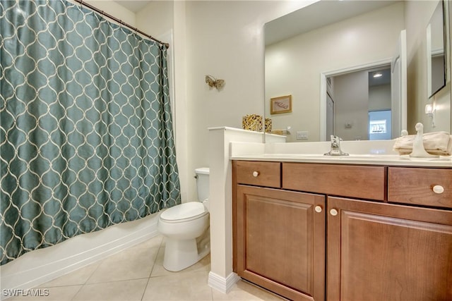 bathroom featuring vanity, tile patterned floors, and toilet