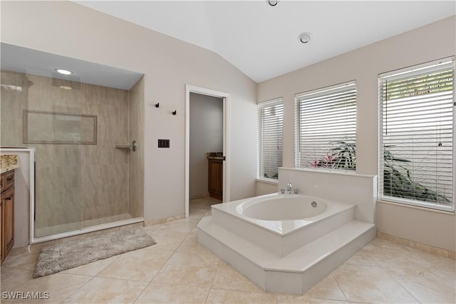 bathroom featuring vanity, lofted ceiling, tile patterned floors, and separate shower and tub