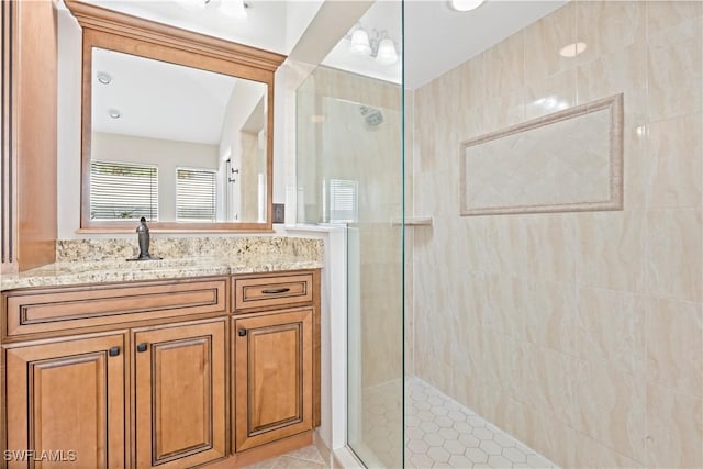 bathroom with vanity, tile patterned floors, and tiled shower