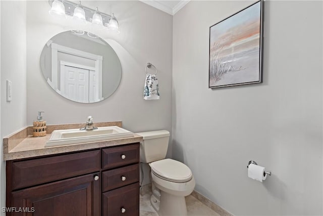 bathroom with vanity, crown molding, tile patterned floors, and toilet