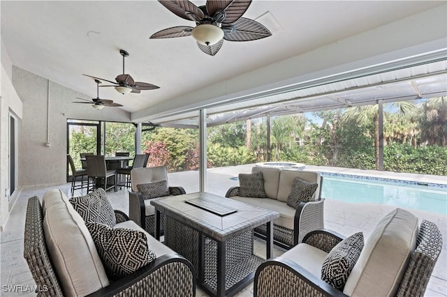 sunroom with lofted ceiling and ceiling fan