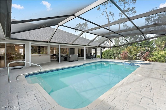 view of pool with an in ground hot tub, a lanai, and a patio