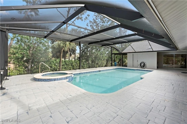 view of pool with a patio area, an in ground hot tub, and glass enclosure