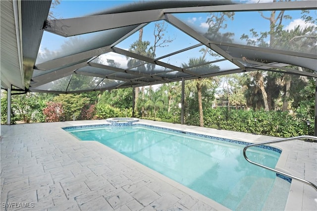 view of pool featuring an in ground hot tub, a patio area, and glass enclosure