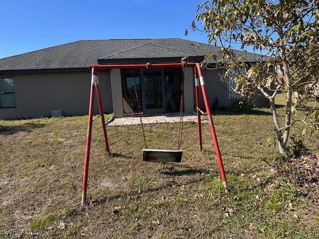 rear view of house with a yard and a patio area