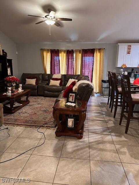 tiled living room featuring ceiling fan