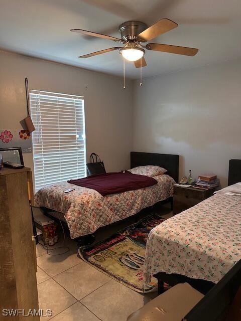 bedroom featuring light tile patterned floors and ceiling fan