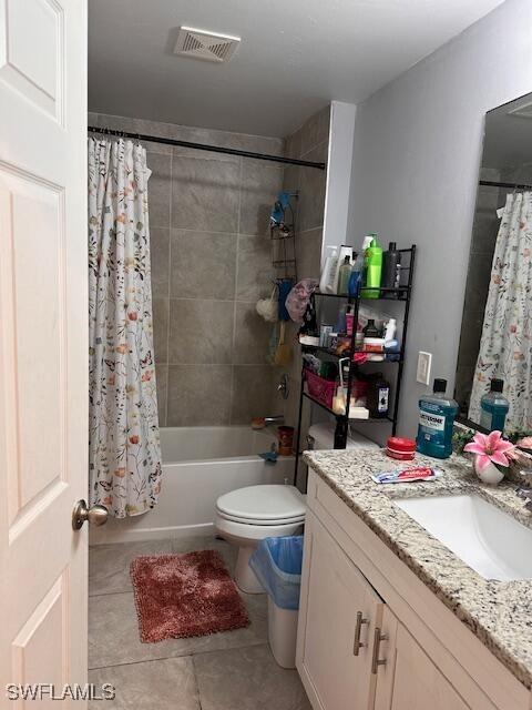 full bathroom featuring tile patterned flooring, vanity, shower / tub combo, and toilet