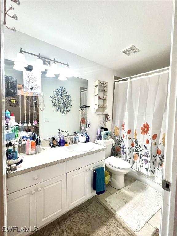 bathroom with hardwood / wood-style flooring, vanity, and toilet