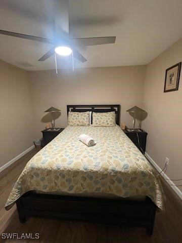 bedroom featuring ceiling fan and dark hardwood / wood-style floors