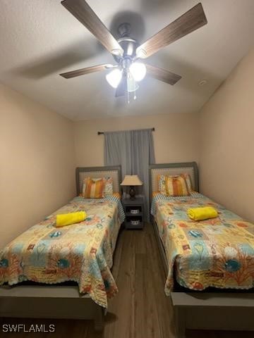 bedroom with dark wood-type flooring and ceiling fan