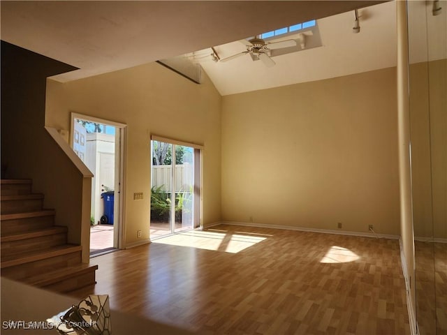 interior space with wood-type flooring, high vaulted ceiling, and ceiling fan