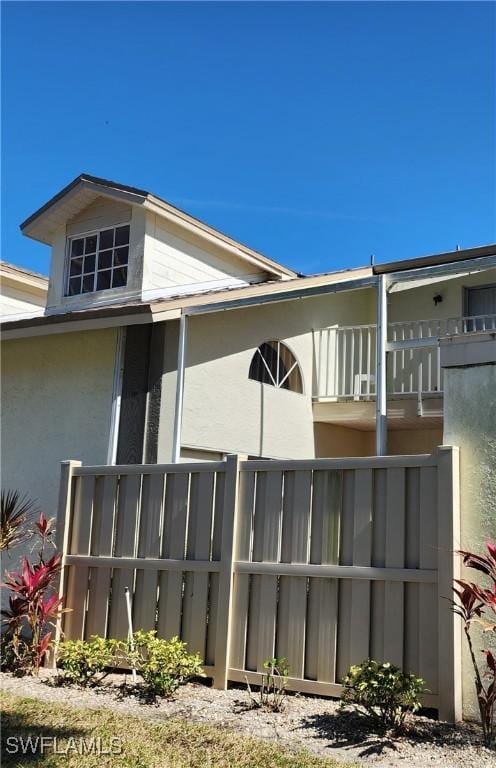 view of side of home featuring a balcony