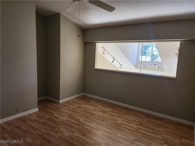 spare room featuring hardwood / wood-style flooring and ceiling fan