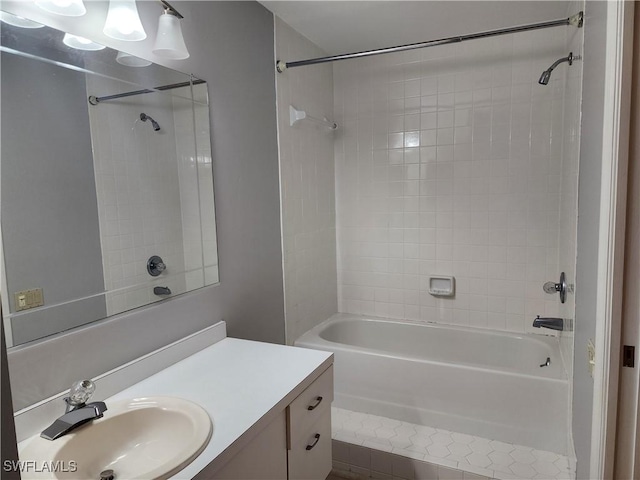 bathroom featuring vanity and tiled shower / bath