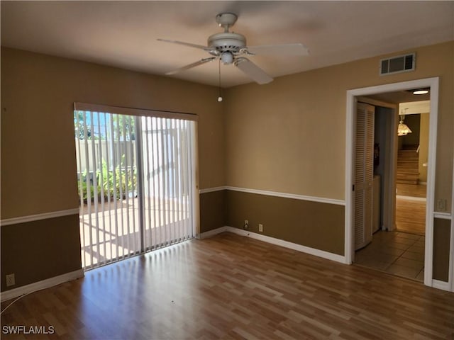 unfurnished room with ceiling fan and wood-type flooring