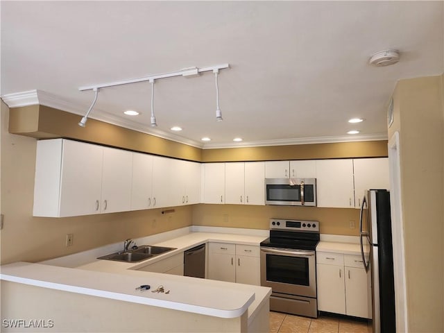 kitchen featuring sink, crown molding, appliances with stainless steel finishes, white cabinetry, and kitchen peninsula