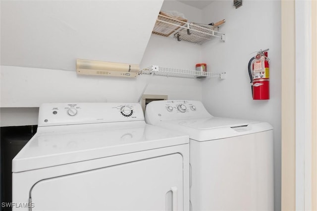 clothes washing area with washer and dryer and laundry area