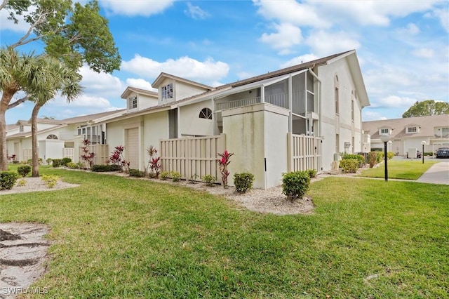 view of front of house featuring a residential view, fence, and a front lawn