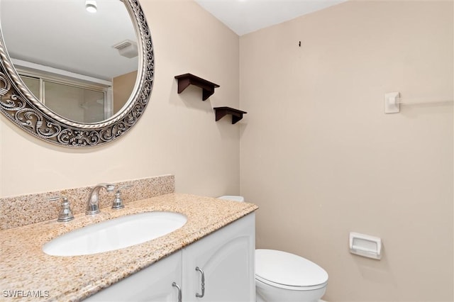 bathroom featuring toilet and vanity