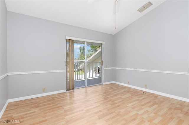 spare room featuring light wood finished floors, visible vents, and baseboards