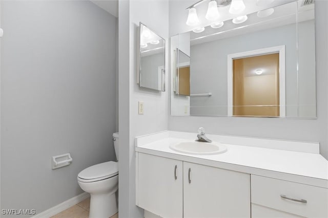 bathroom featuring toilet, visible vents, baseboards, vanity, and tile patterned floors