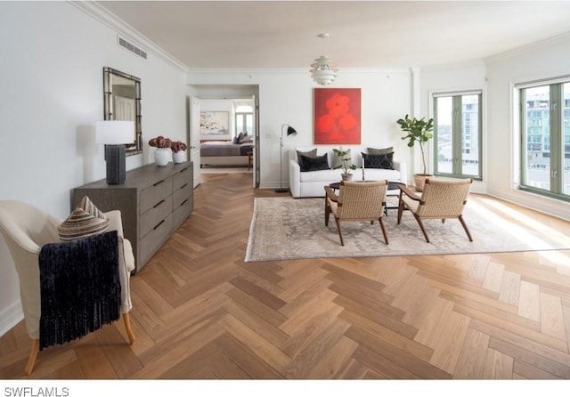 living room with ornamental molding and light parquet flooring