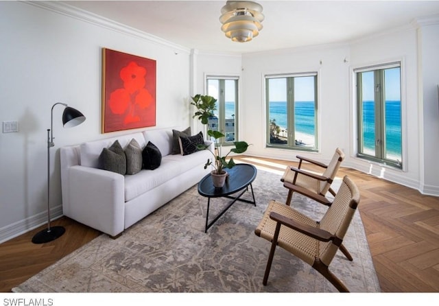 living room with a water view, ornamental molding, and parquet floors