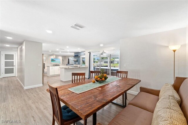 dining room with recessed lighting, visible vents, light wood-style flooring, and baseboards