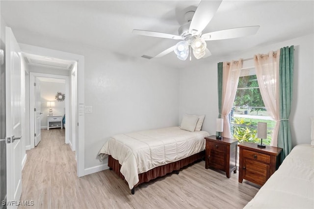 bedroom with visible vents, ceiling fan, light wood-type flooring, and baseboards