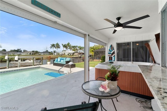 outdoor pool with a hot tub, a lanai, outdoor dining space, a ceiling fan, and a patio
