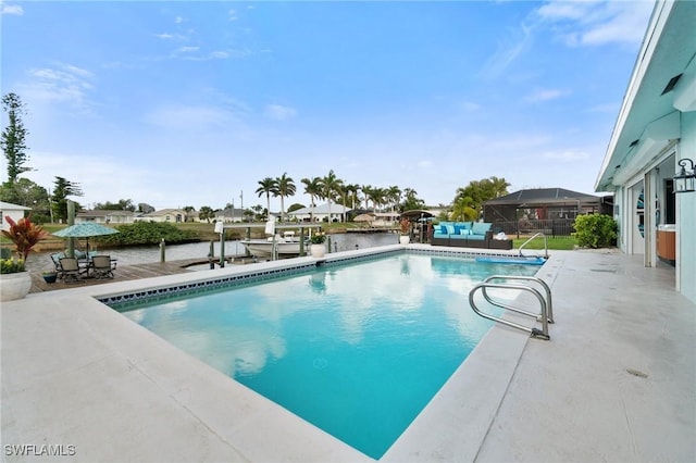 outdoor pool with a patio, fence, and a boat dock