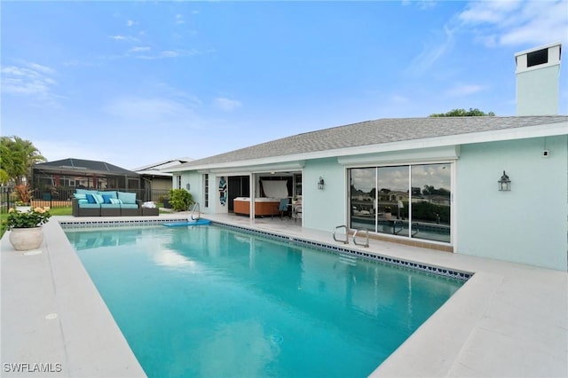 view of swimming pool with outdoor lounge area, a patio, a fenced in pool, and fence