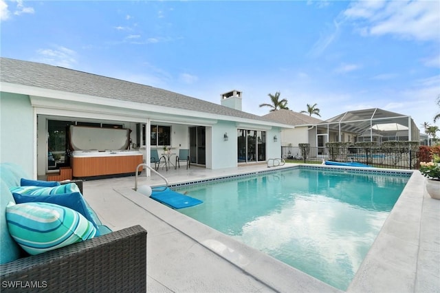 view of pool with a fenced in pool, fence, a hot tub, and a patio area