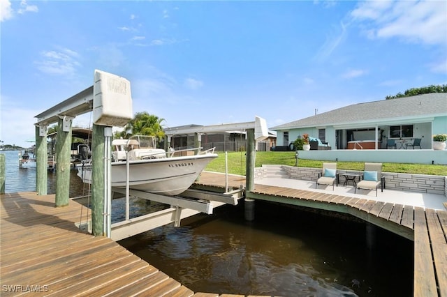 dock area featuring boat lift and a water view