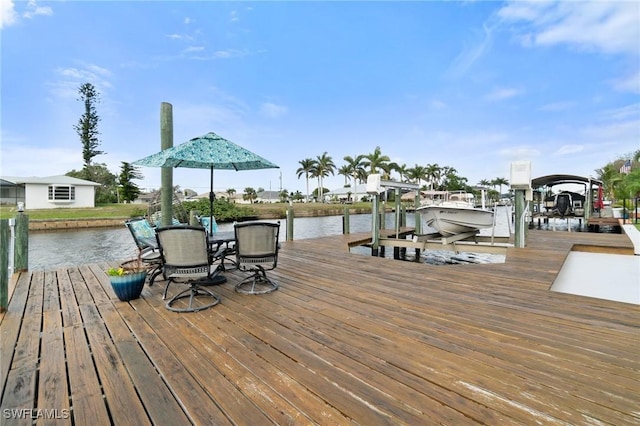 dock area featuring boat lift and a water view