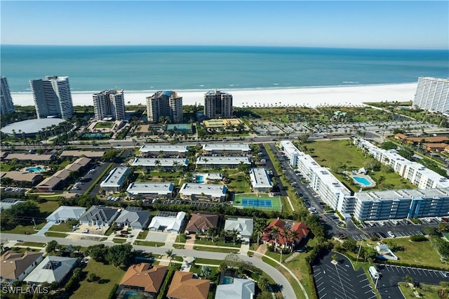 bird's eye view with a water view and a beach view