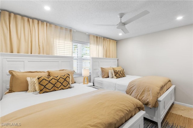 bedroom featuring ceiling fan and a textured ceiling