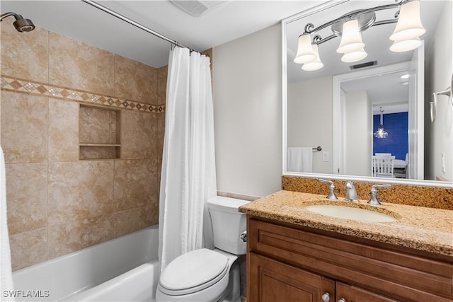 full bathroom featuring vanity, toilet, and shower / tub combo