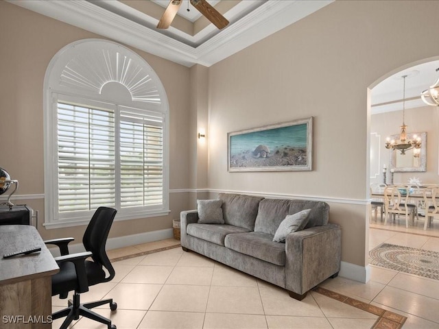 office space featuring a raised ceiling, crown molding, ceiling fan with notable chandelier, and light tile patterned floors