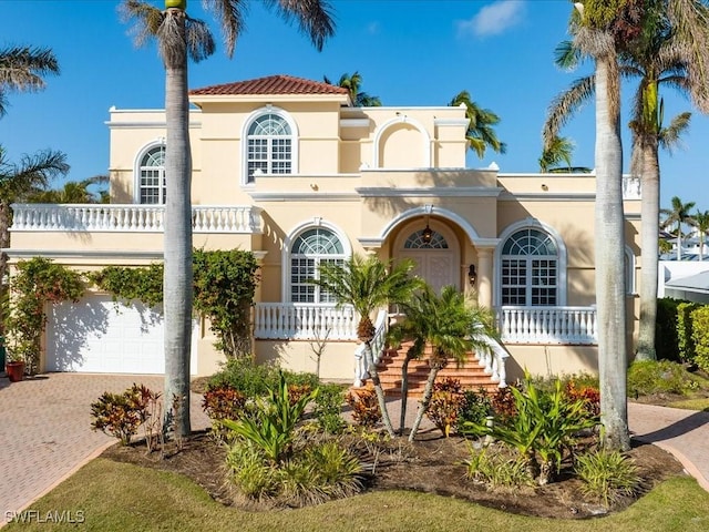 mediterranean / spanish-style home with a garage