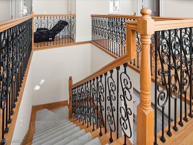 staircase with wood-type flooring