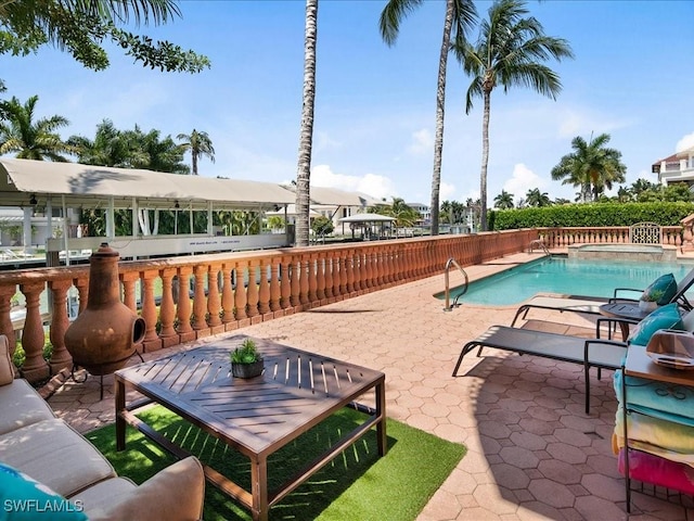 view of pool featuring an in ground hot tub and a patio