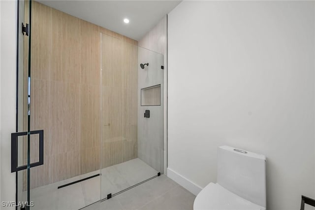 bathroom with tile patterned floors, toilet, and walk in shower