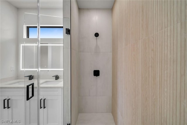 bathroom with walk in shower and vanity