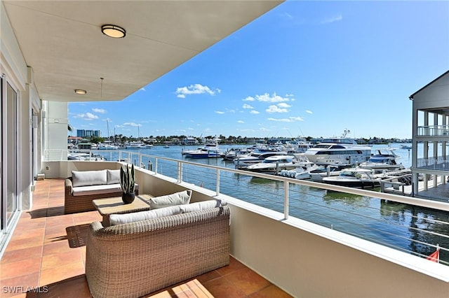 balcony featuring a water view and outdoor lounge area