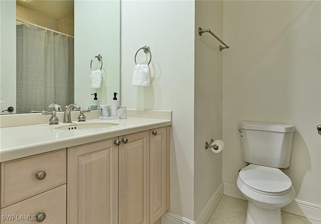 bathroom with vanity, tile patterned floors, and toilet