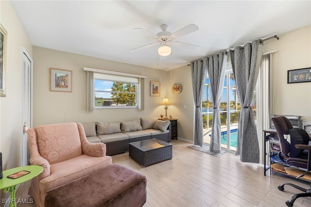 403 SE 28th Ter, Cape Coral, FL 33904 - living room with a ceiling fan, baseboards, and light wood-style floors