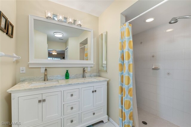 bathroom with vanity, curtained shower, and ceiling fan